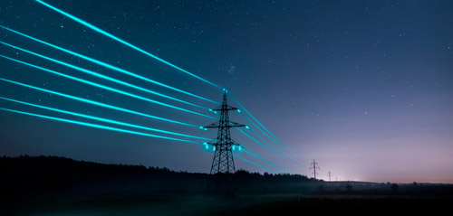 Electricity,Transmission,Towers,With,Glowing,Wires,Against,The,Starry,Sky.